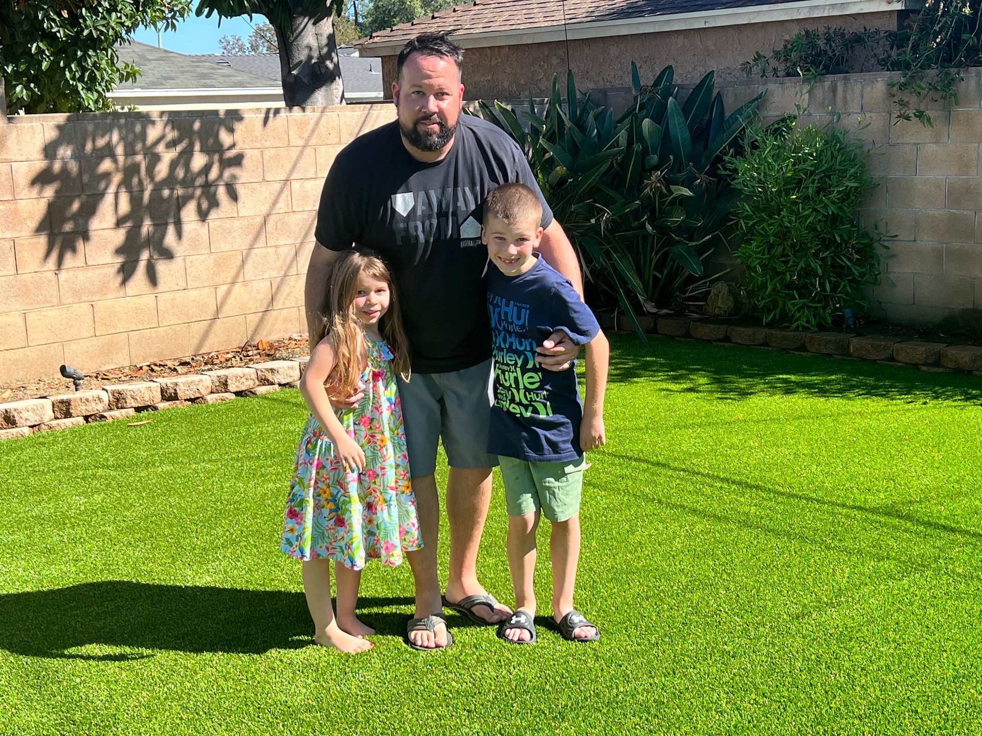 family on fake grass GG