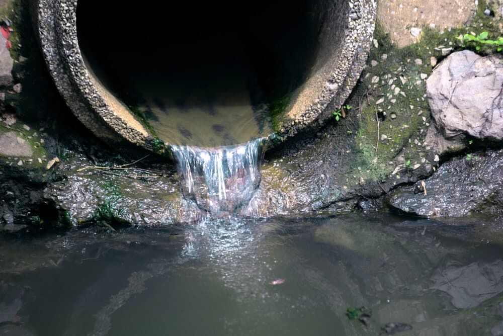Water is Coming Out of a Pipe Into a Body of Water — Tony Gordon Septic Tank Cleaning in Newee Creek, NSW