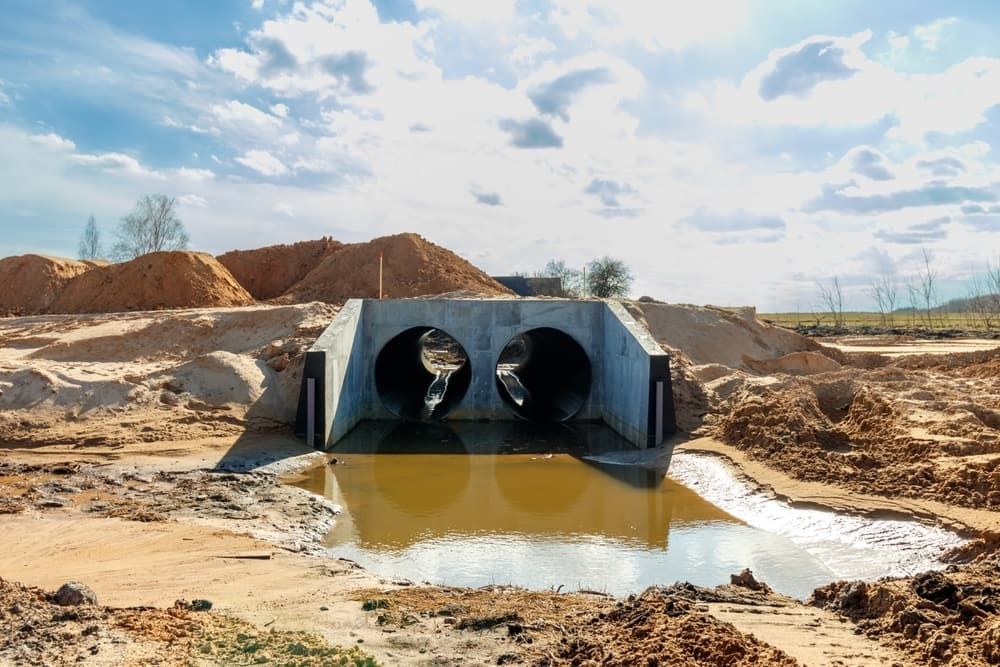 A Bridge is Being Built Over a Body of Water — Tony Gordon Septic Tank Cleaning in Coffs Harbour, NSW
