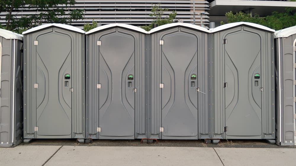 A Row of Portable Toilets Are Lined Up on the Sidewalk — Tony Gordon Septic Tank Cleaning in Newee Creek, NSW
