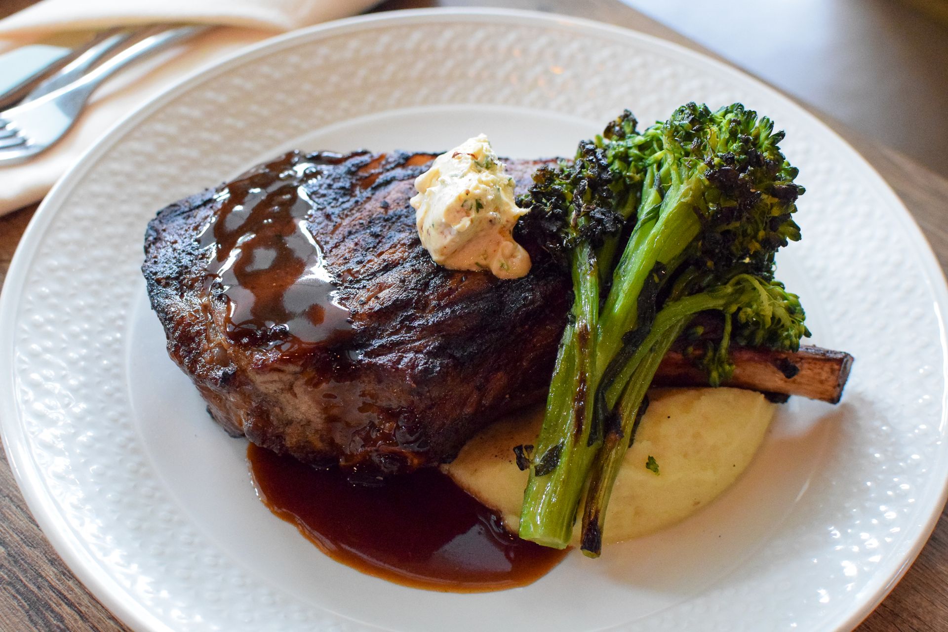 Bone-In Ribeye at Gallion's Bone-in ribeye with broccolini and potatoes at Gallion's in Rosemary Beach