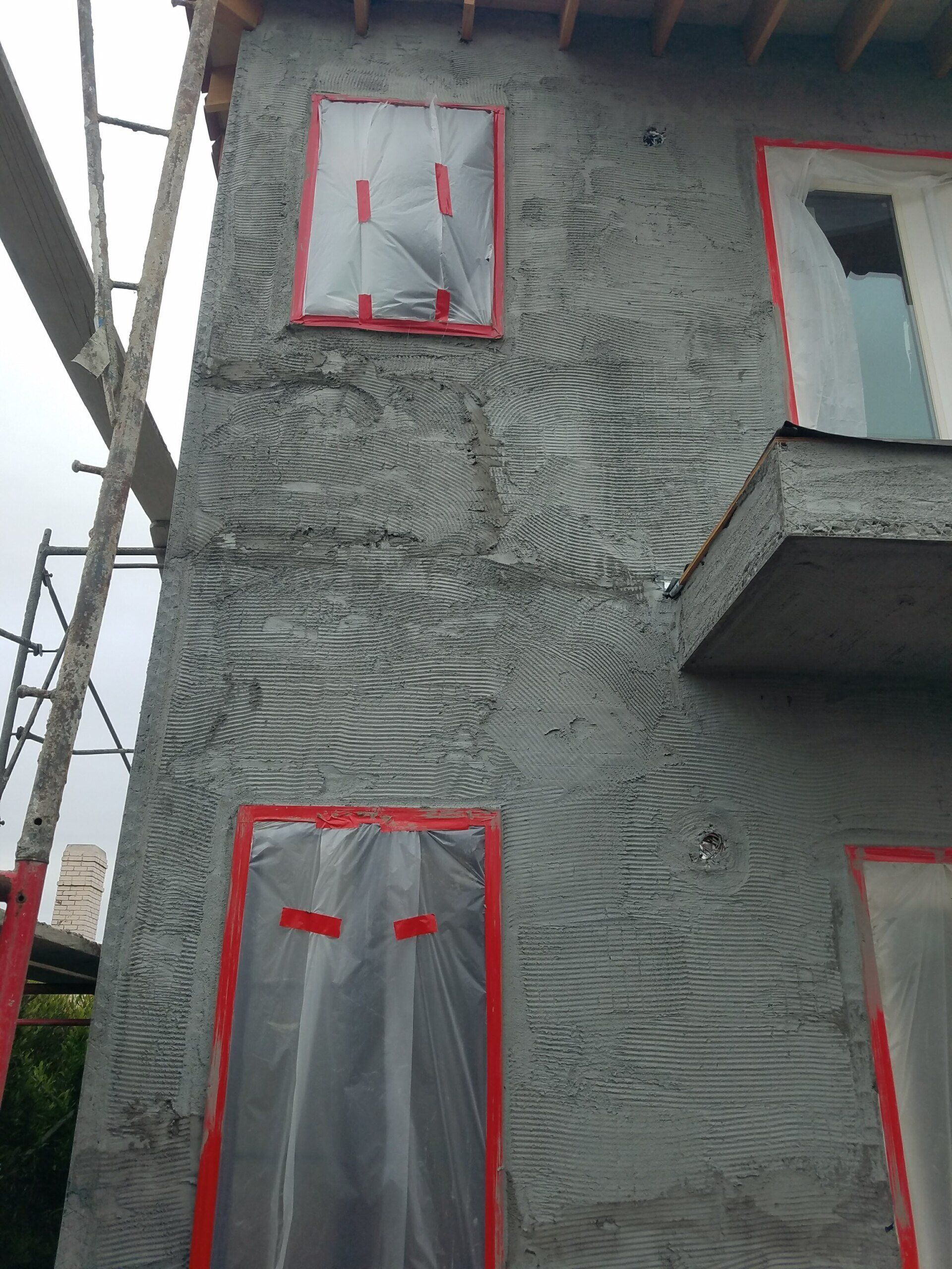A building that is being built with a ladder in the background