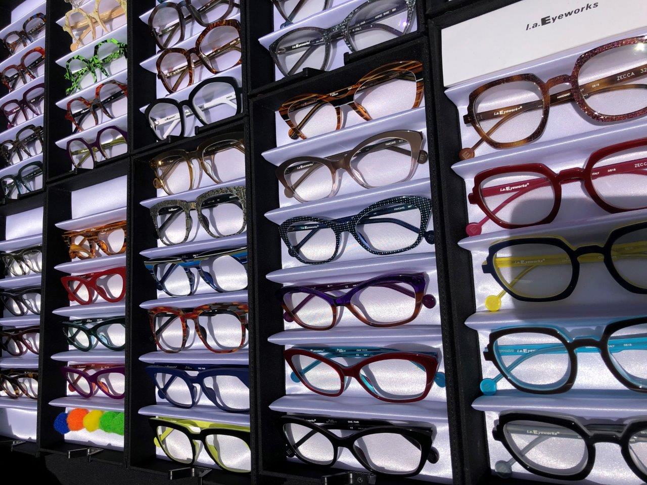 Many colorful eyeglass frames in display boxes at Raise Your Glasses 2019 Event