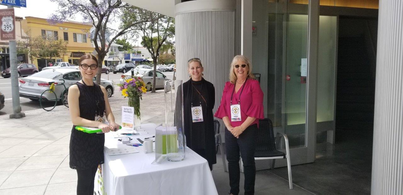 Staff at outside reception table at Raise Your Glasses 2019 Event