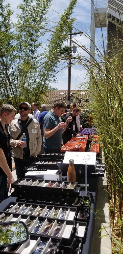 People trying on frames while standing outside at Raise Your Glasses 2019 Event