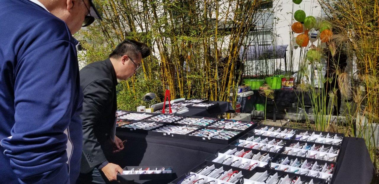 Person looking at tables filled with frameline displays at Raise Your Glasses 2019 Event