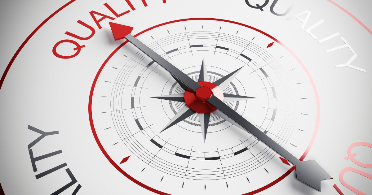 A compass with a red arrow pointing to the word quality