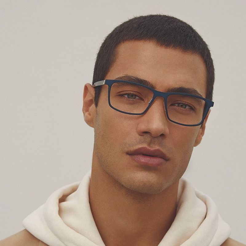 Man in a Hoodie wearing a dark blue pair of ALIUM eyewear