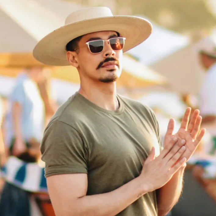Man in a t-shirt and straw hat wearing silver Booth & Bruce frame sunglasses