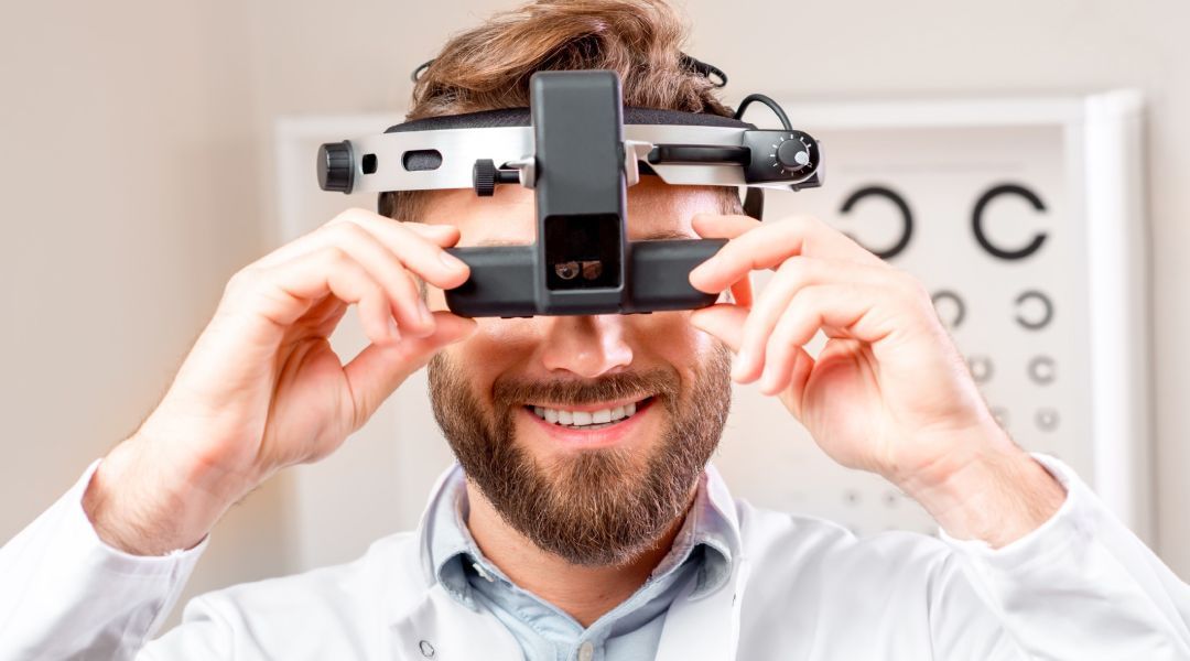 Optometrist with an eye examination device on his head