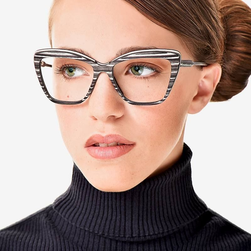 A woman wearing a black and white striped glasses