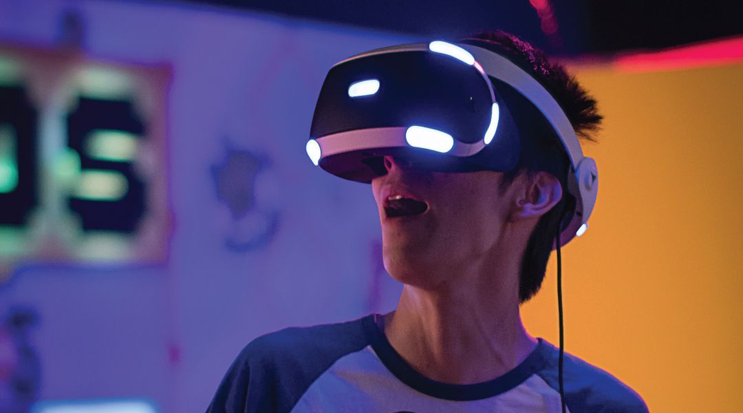 Person wearing an augmented reality viewer with an expression of awe on her face