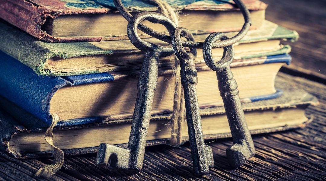 Stack of vintage books with old skeleton keys on a ring