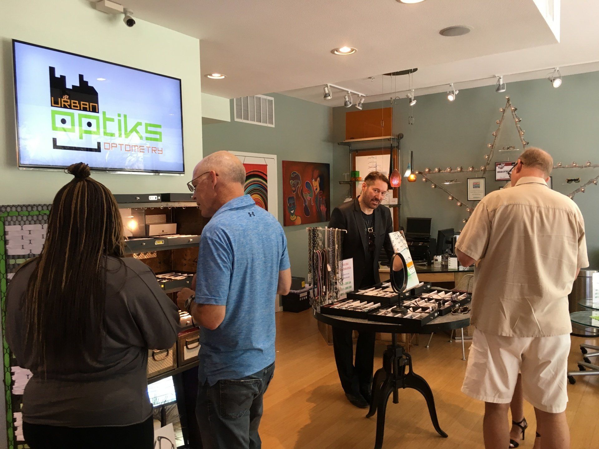 People standing inside Urban Optiks Optometry at 2016 trunk show event