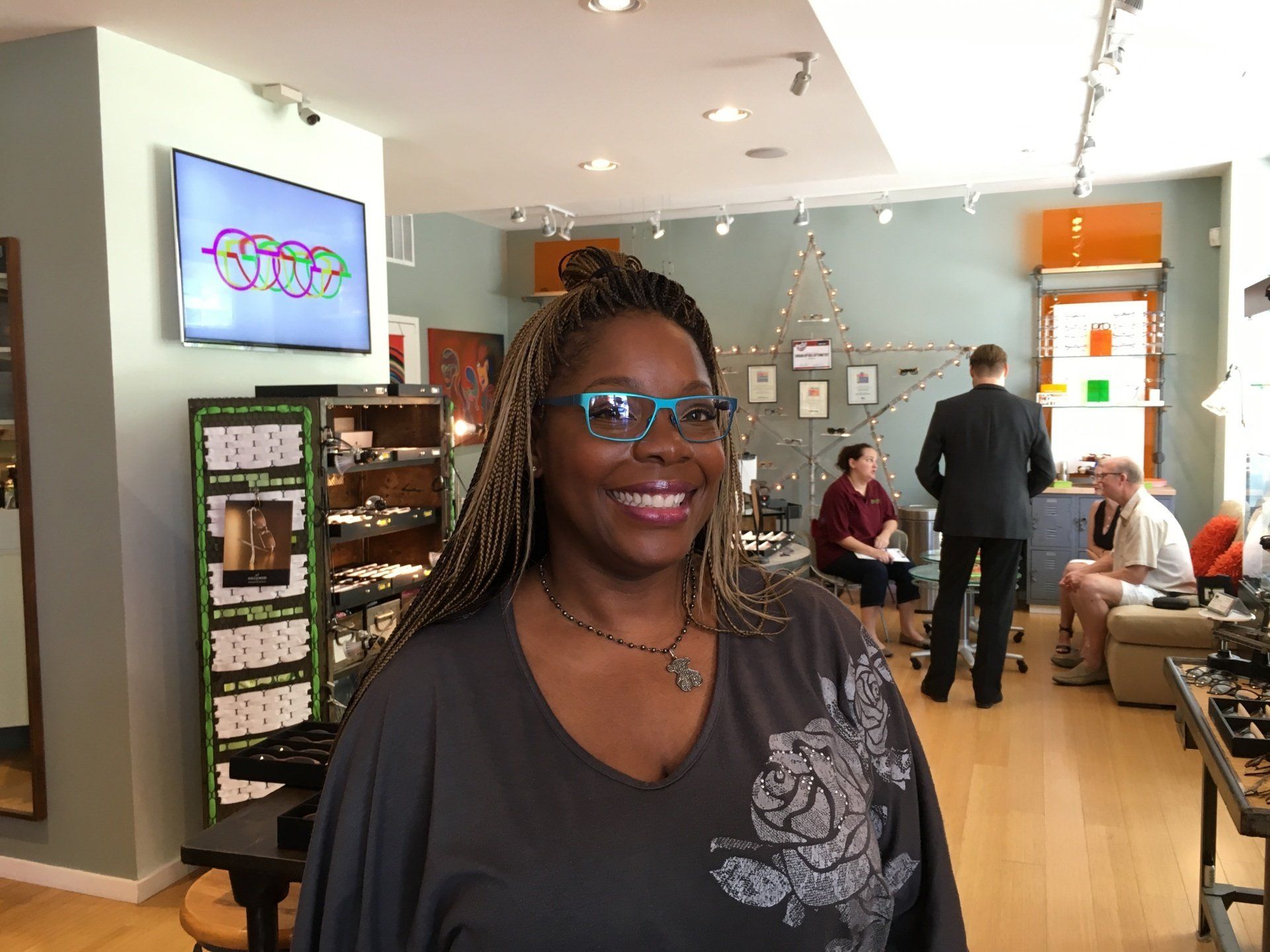 Person modeling blue frames at 2016 trunk show event