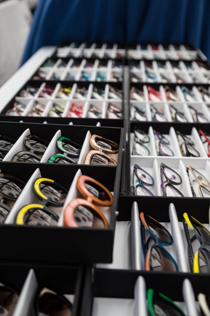 Black display boxes of colorful framelines at 2018 Raise Your Glasses