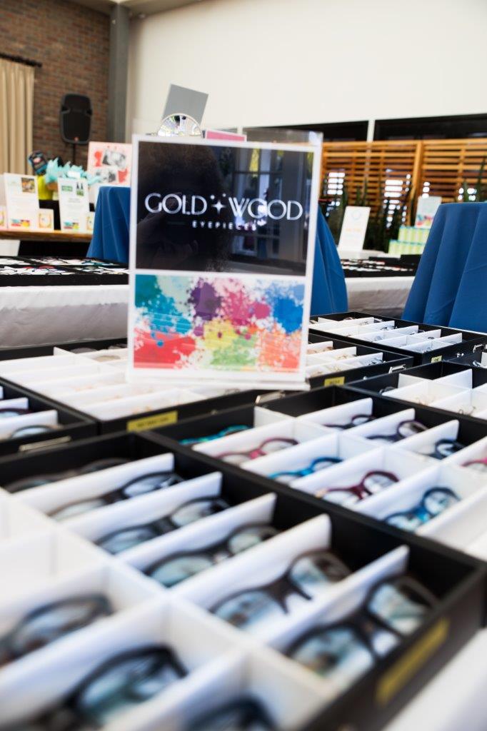 Gold and Wood sign and tabletop display at 2018 Raise Your Glasses