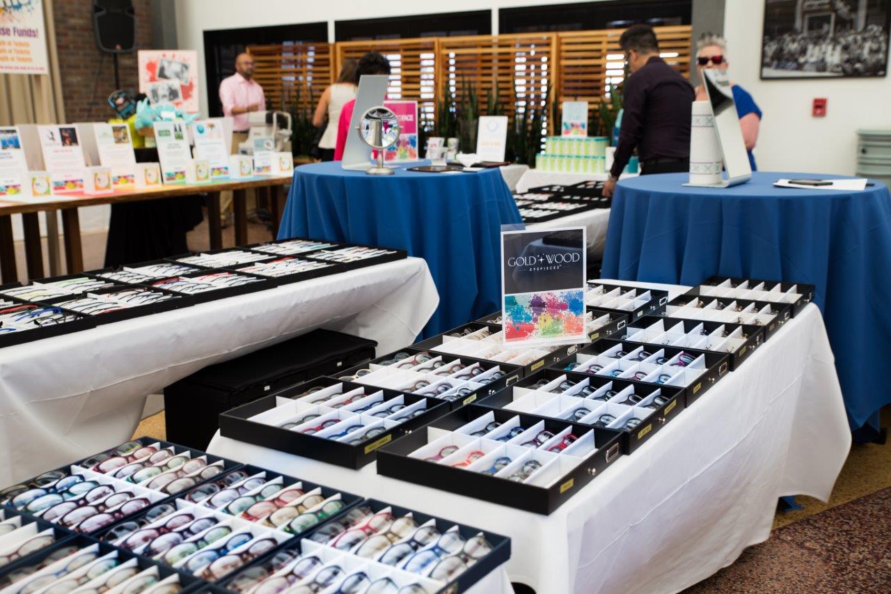 Various tabletop eyewear displays inside venue at 2018 Raise Your Glasses