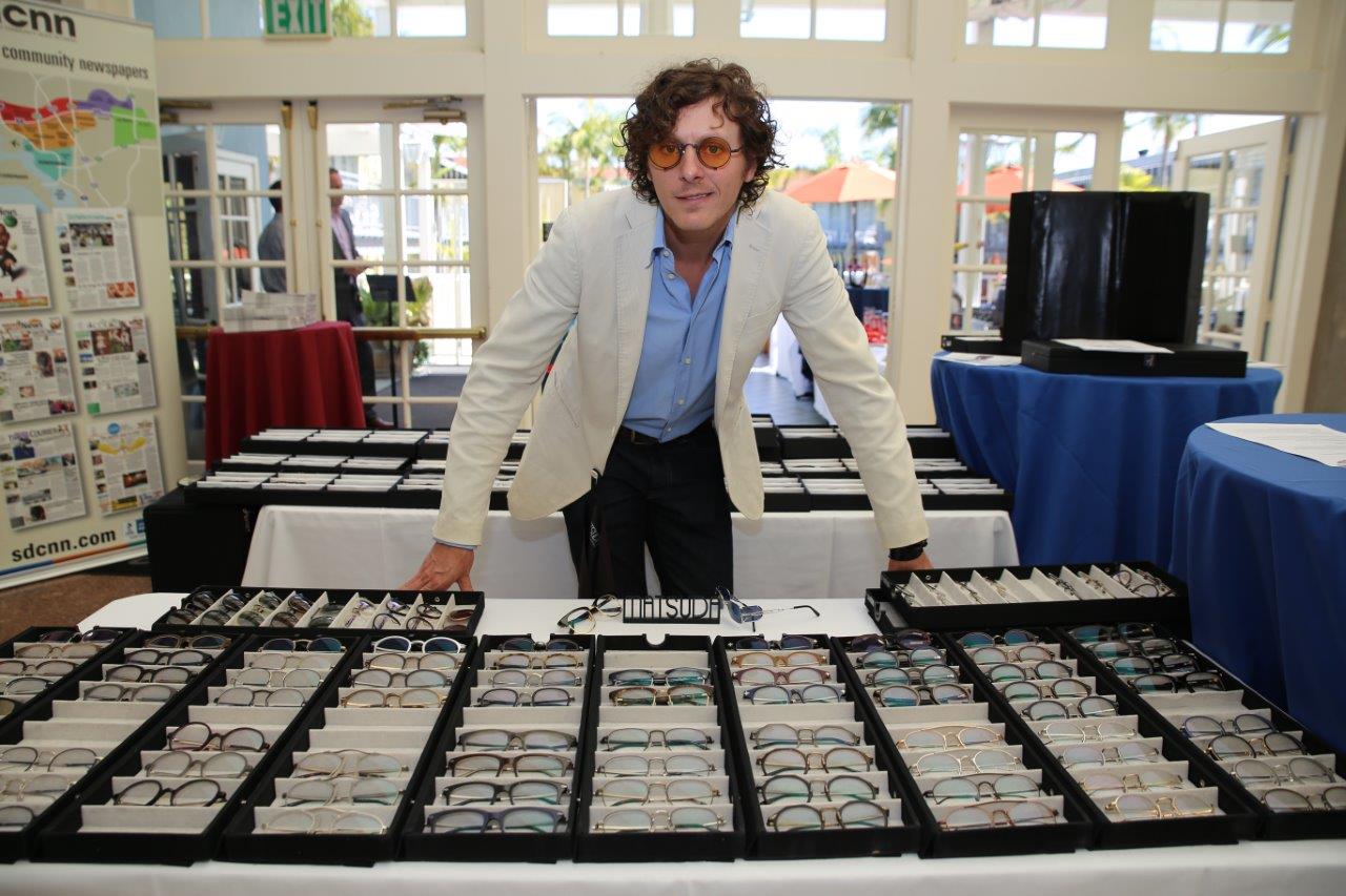 Matsuda vendor standing behind tabletop eyewear display at 2018 Raise Your Glasses