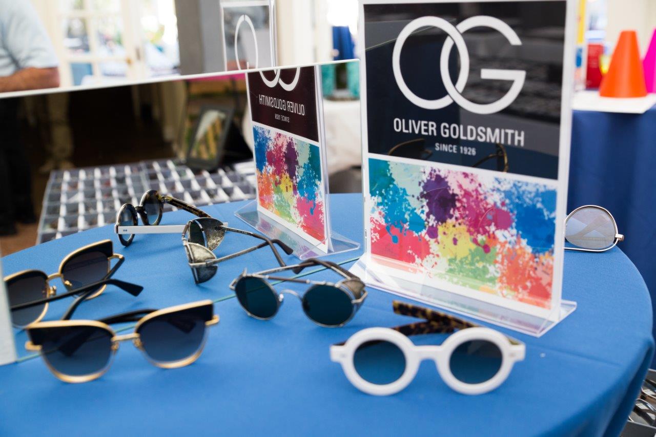 Sunglass frames on tabletop display of Oliver Goldsmith eyewear at 2018 Raise Your Glasses