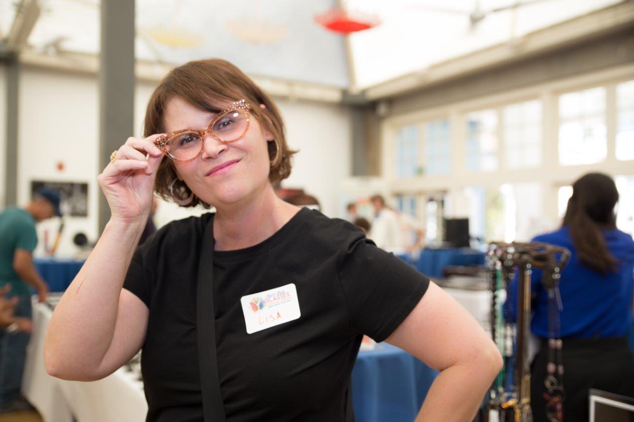 Person in black blouse modeling eyewear at 2018 Raise Your Glasses