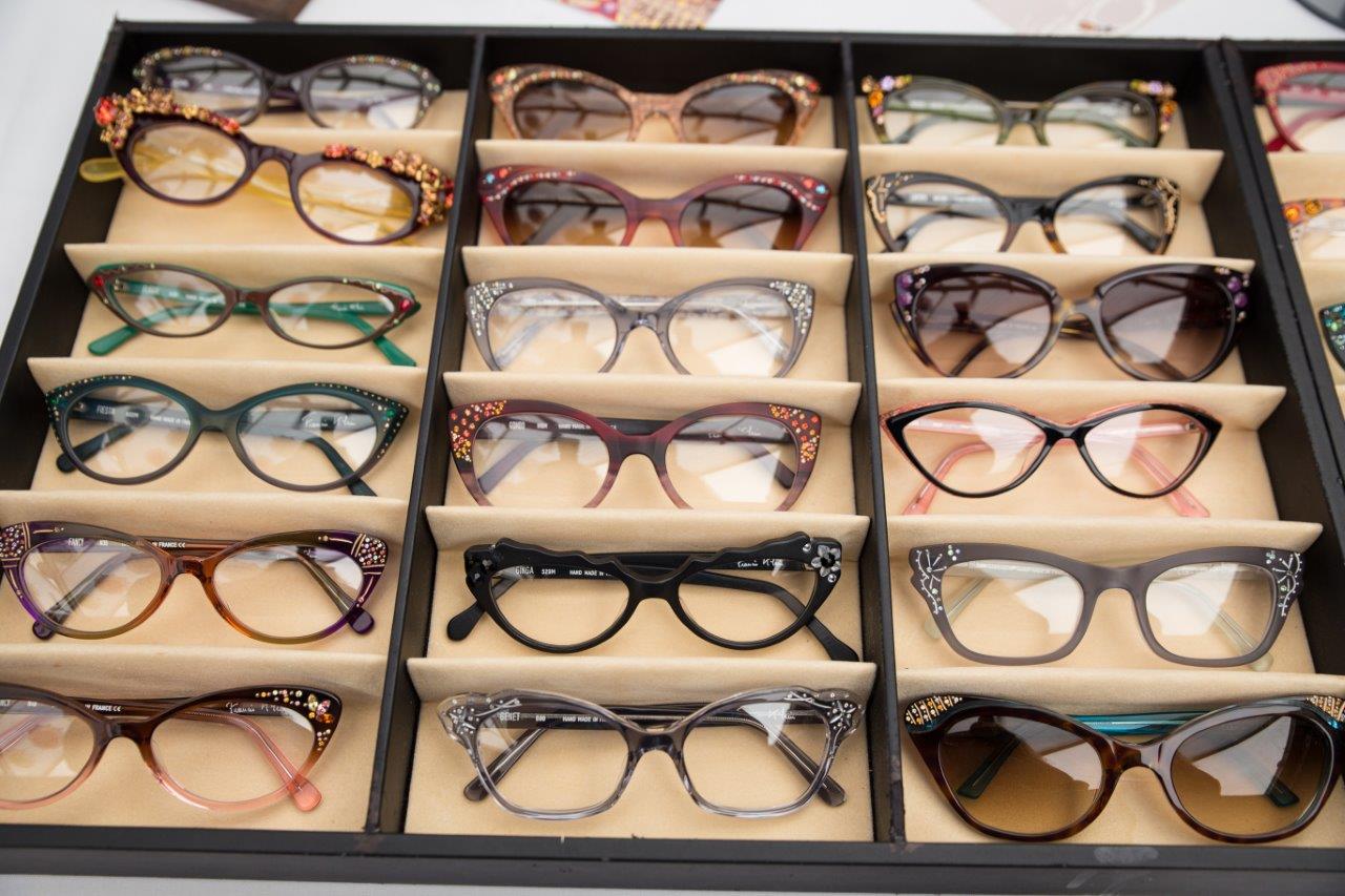Many eyeglass frames in black display boxes at 2018 Raise Your Glasses