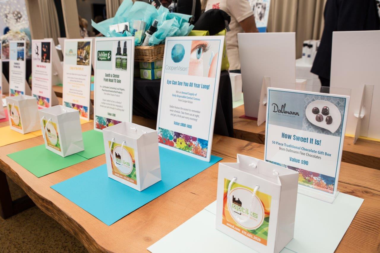More banners and shopping bags with drawing prize info at 2018 Raise Your Glasses