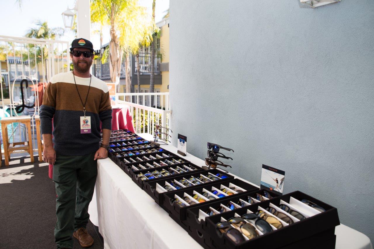 Person standing near display boxes of sunglass frames at Raise Your Glasses 2018 Event