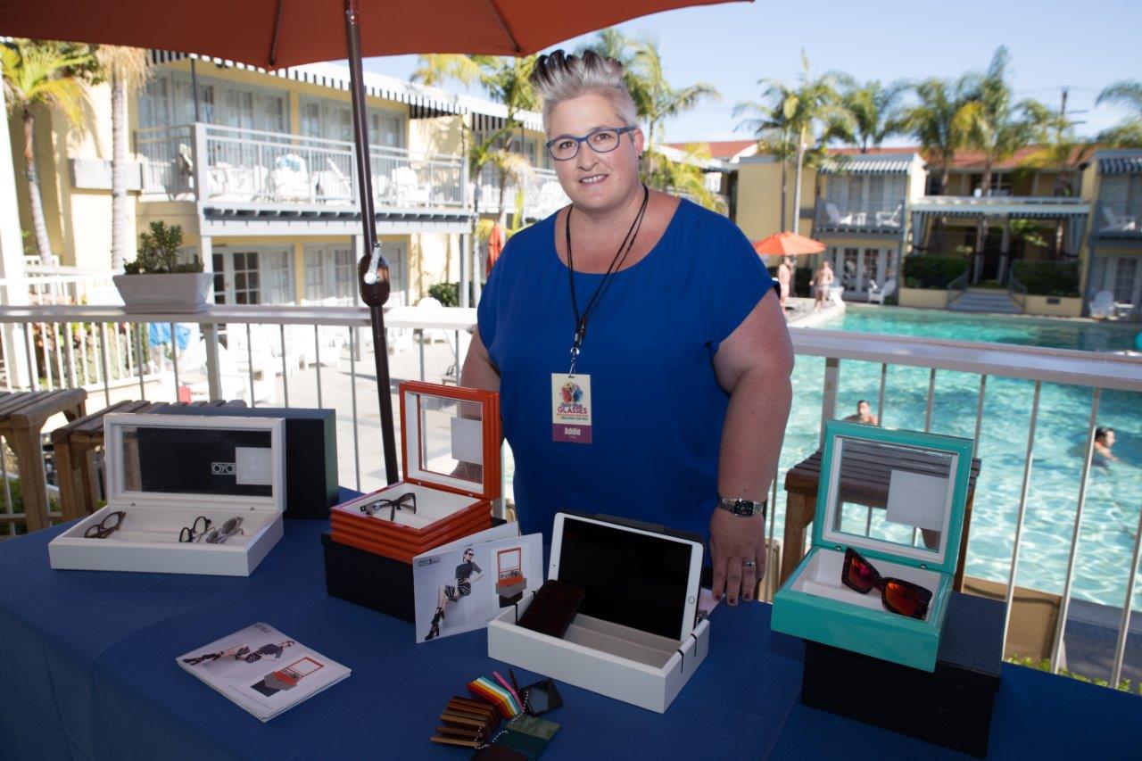 Vendor showing off display boxes at outdoor table at Raise Your Glasses 2018 Event