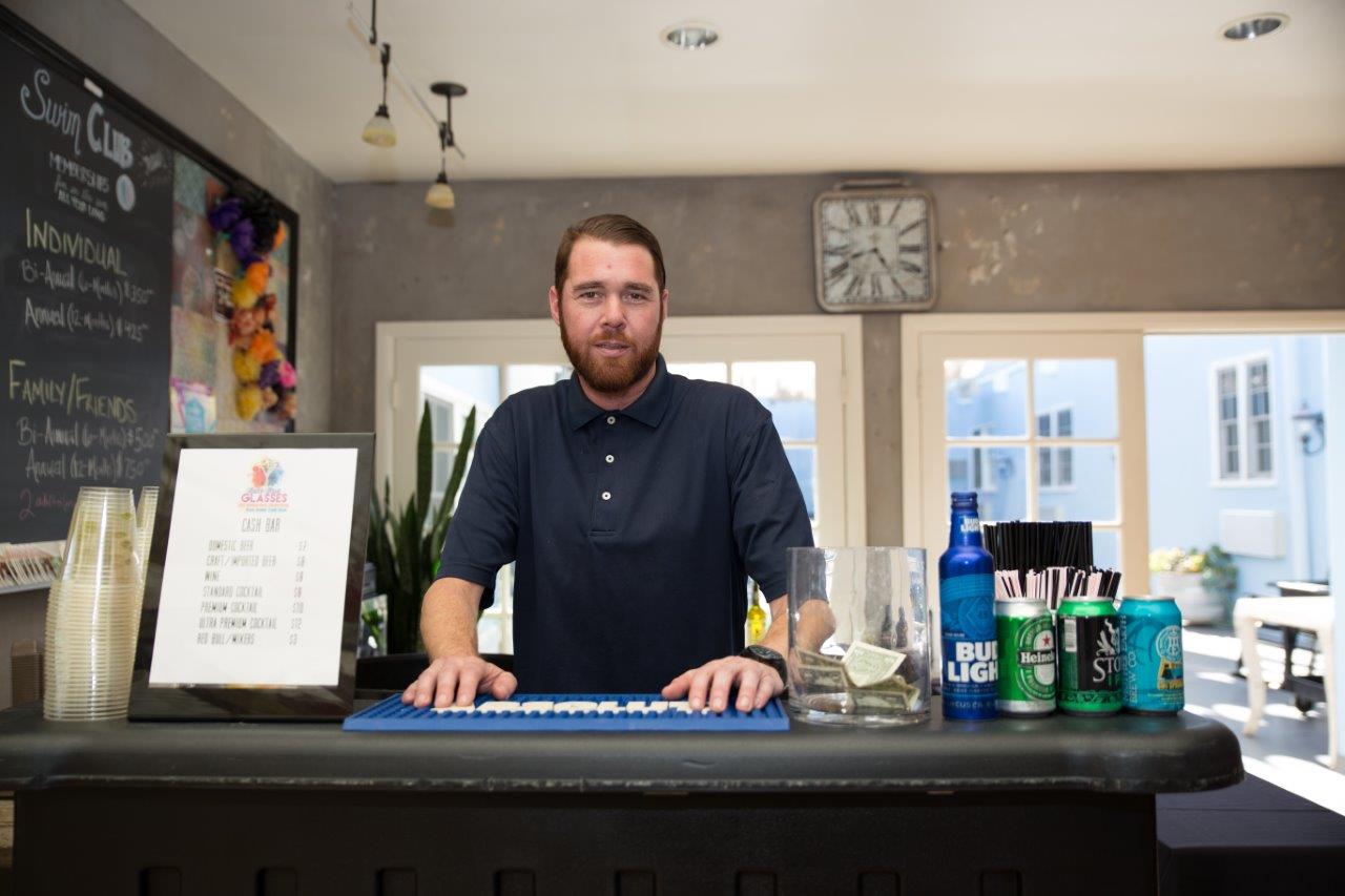 Bartender standing behind bar at Raise Your Glasses 2018 Event