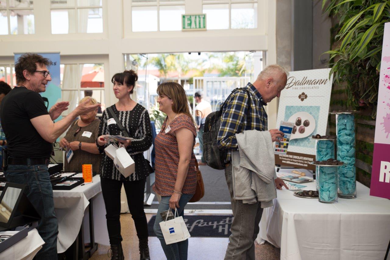 2 attendees chatting with vendor at Raise Your Glasses 2018 Event