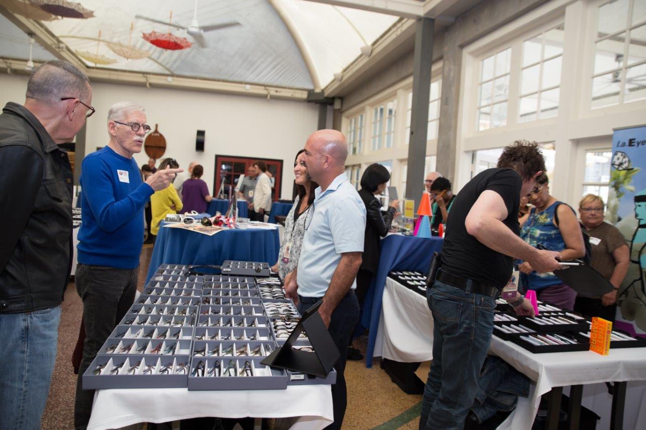 2 attendees chatting with 2 vendors at Raise Your Glasses 2018 Event