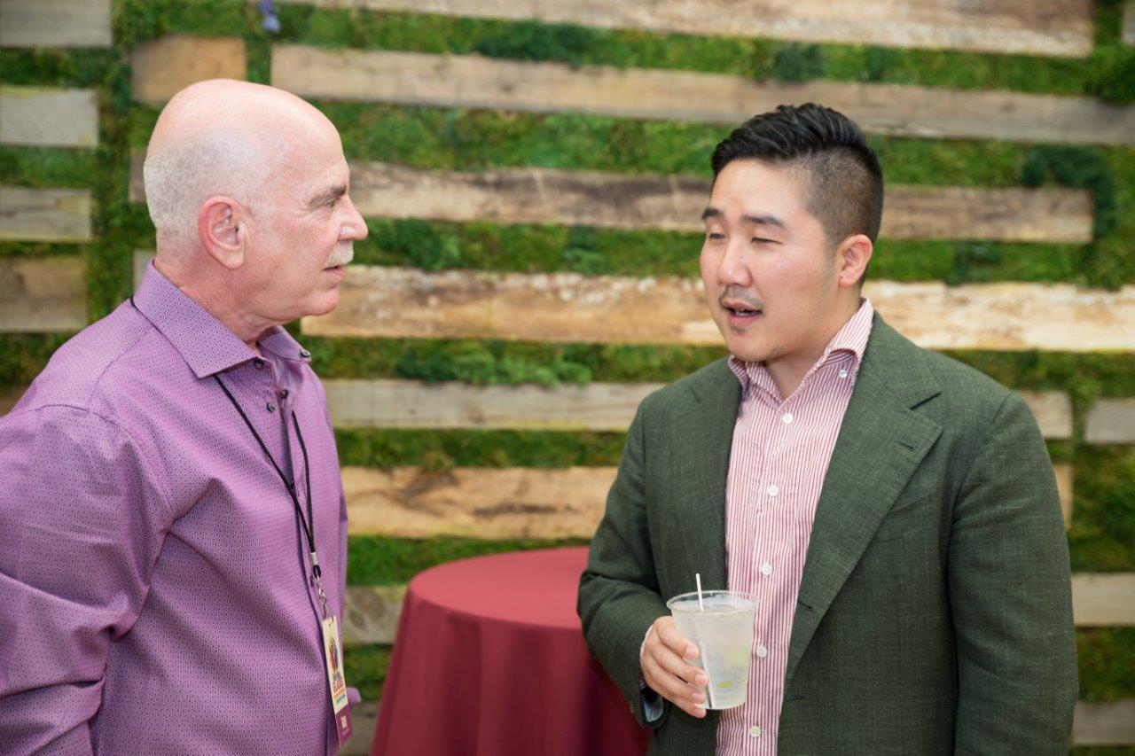 Dr Klein and guest chatting at Raise Your Glasses 2018 Event