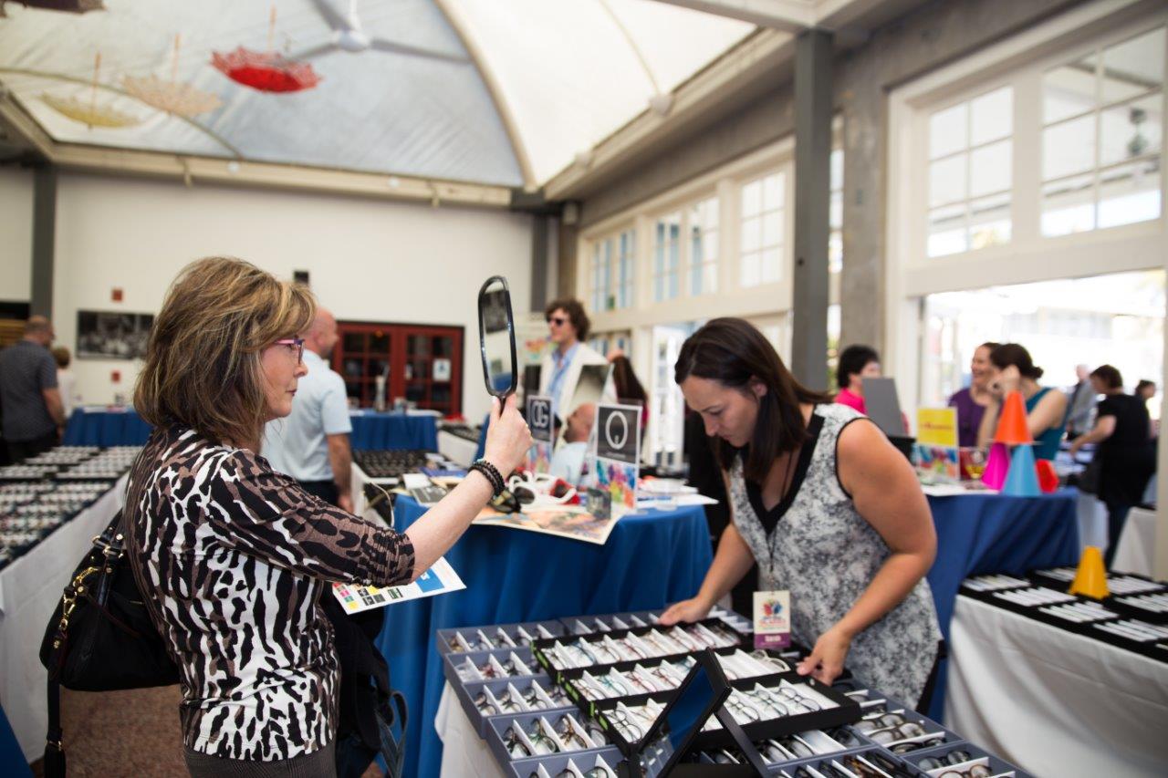 Person trying on eyeglass frames at Raise Your Glasses 2018 Event