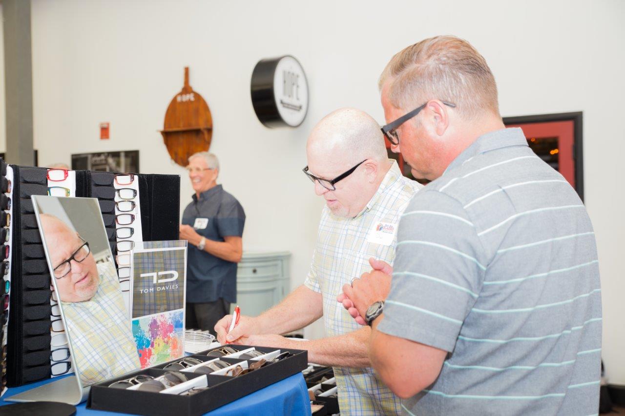 Guest selecting frames to purchase at Raise Your Glasses 2018 Event