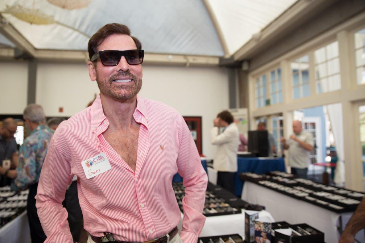Person trying on sunglass frames at Raise Your Glasses 2018 Event