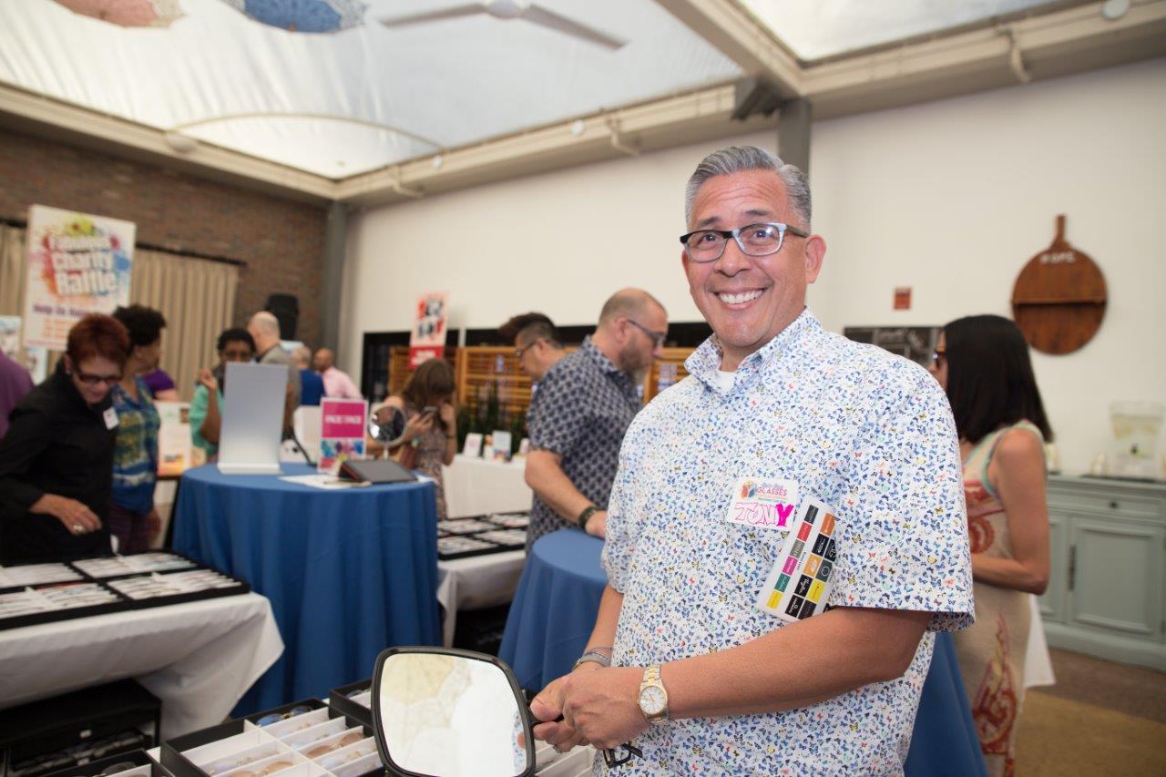 Person trying on frames at Raise Your Glasses 2018 Event