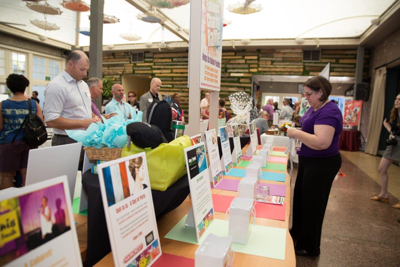 People looking at gift bags for drawings at Raise Your Glasses 2018 Event