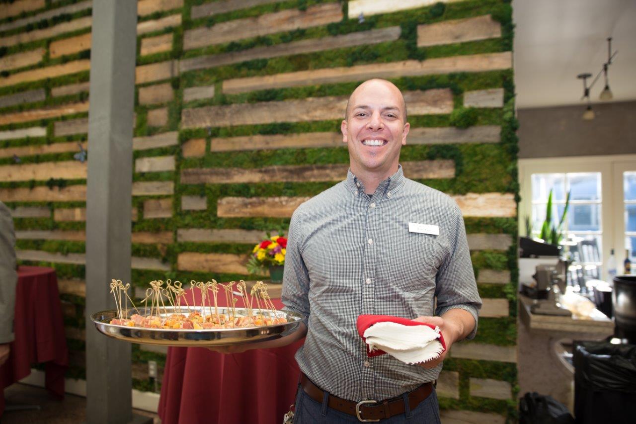 Person holding plate and napkins at Raise Your Glasses 2018 Event