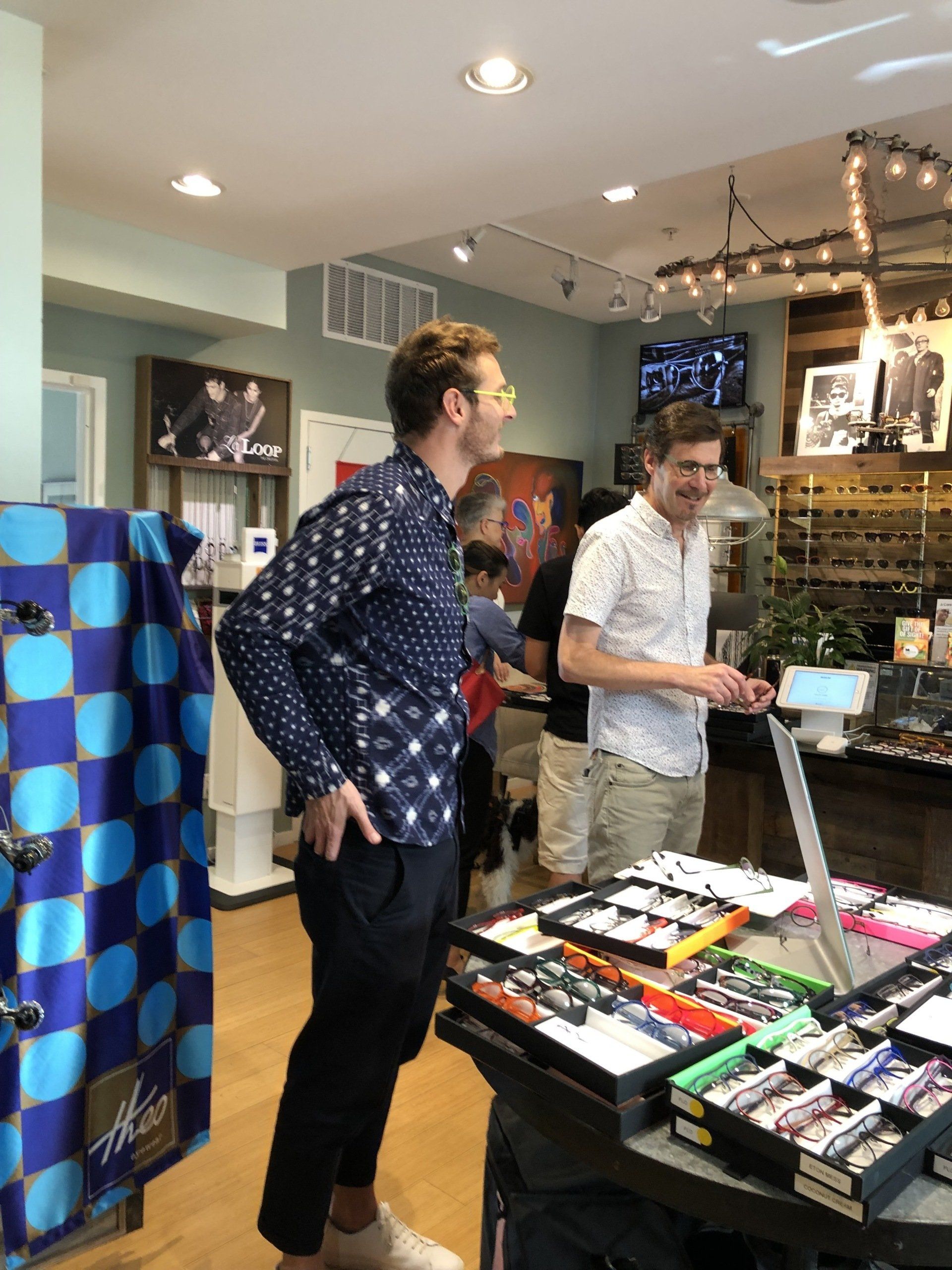 Two people shopping for Theo frames at Theo Trunk Show Event
