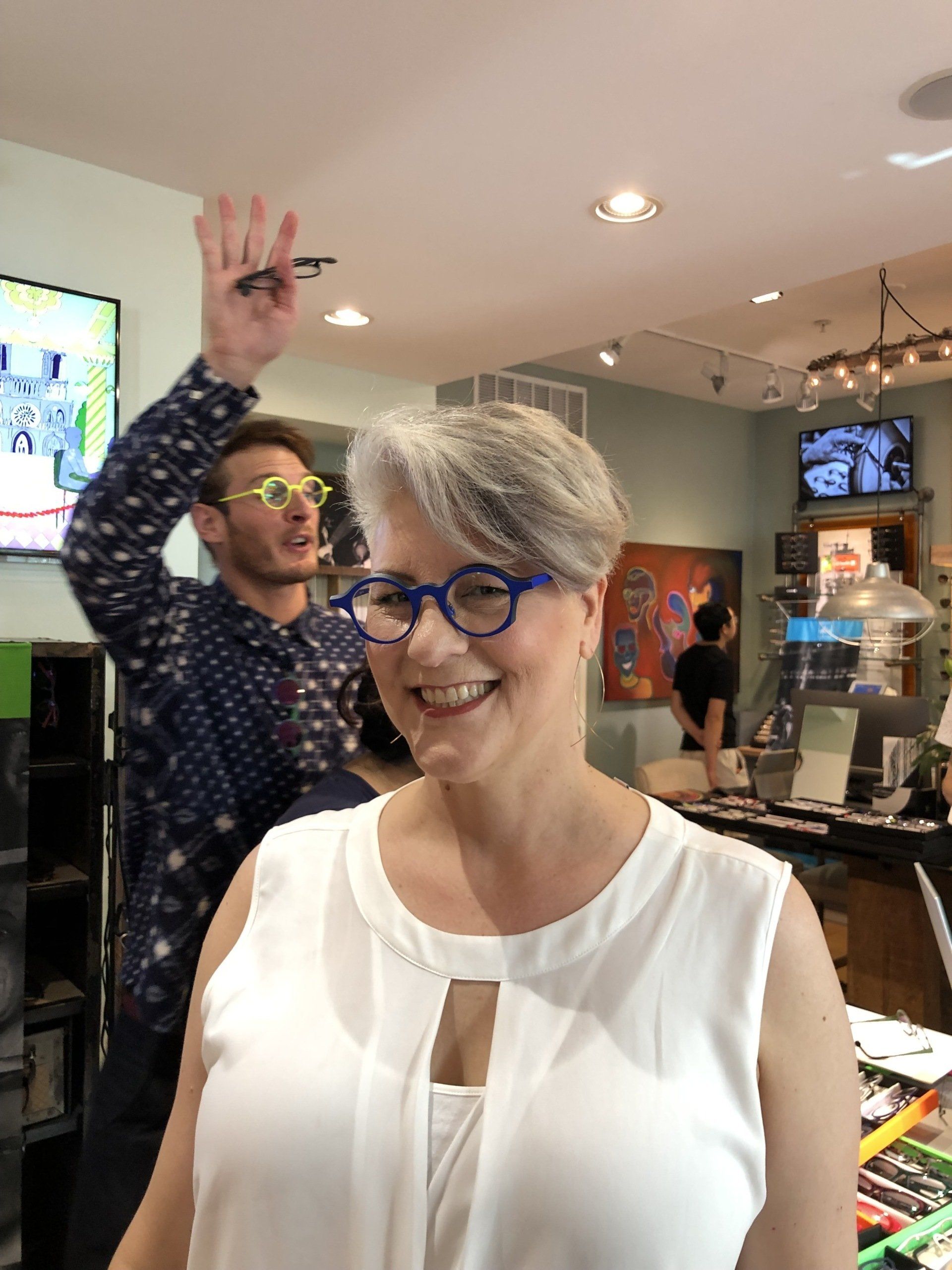 Woman smiling in foreground at Theo Trunk Show Event