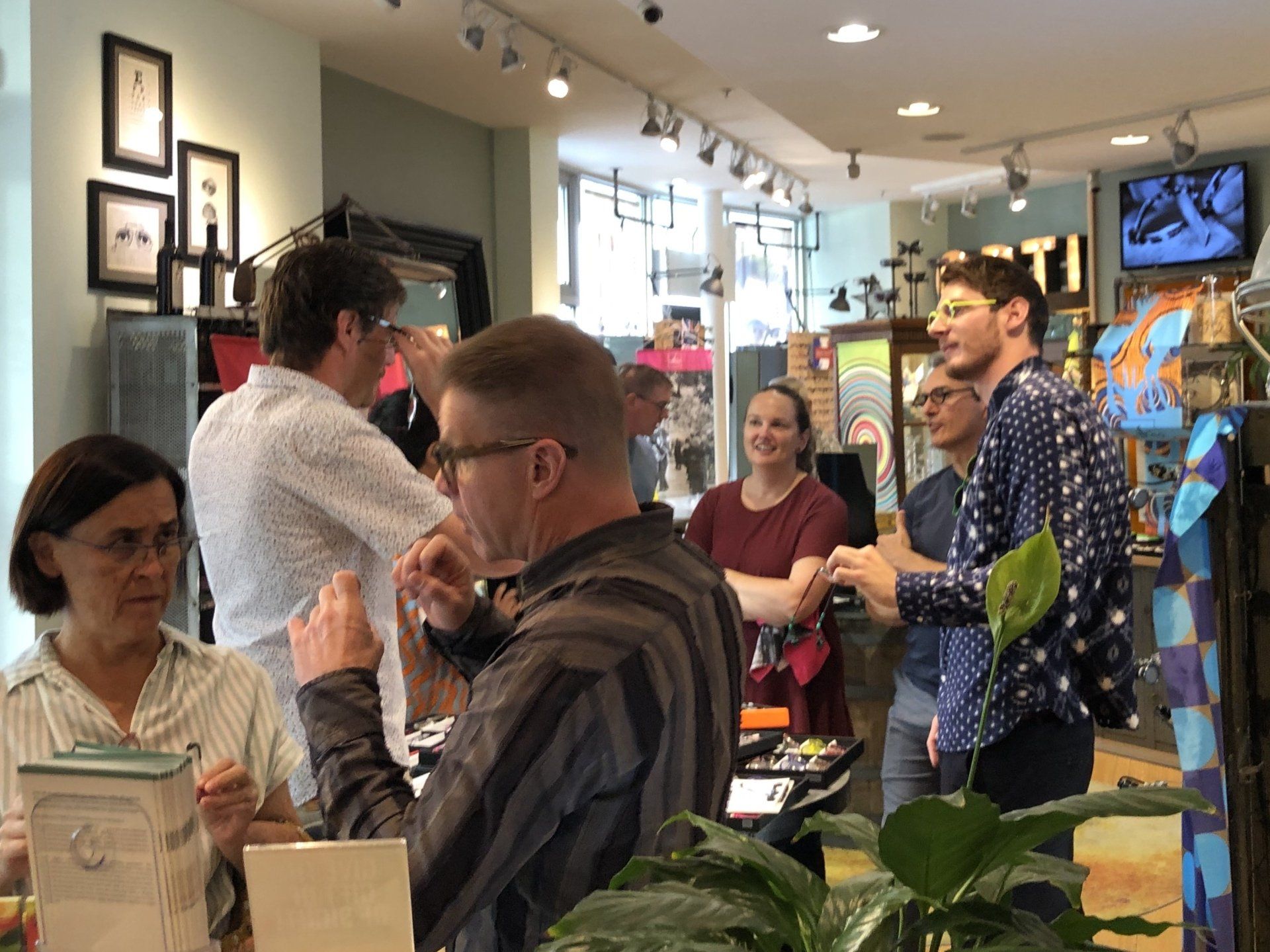 Group of people enjoying Theo Trunk Show Event at Urban Optiks