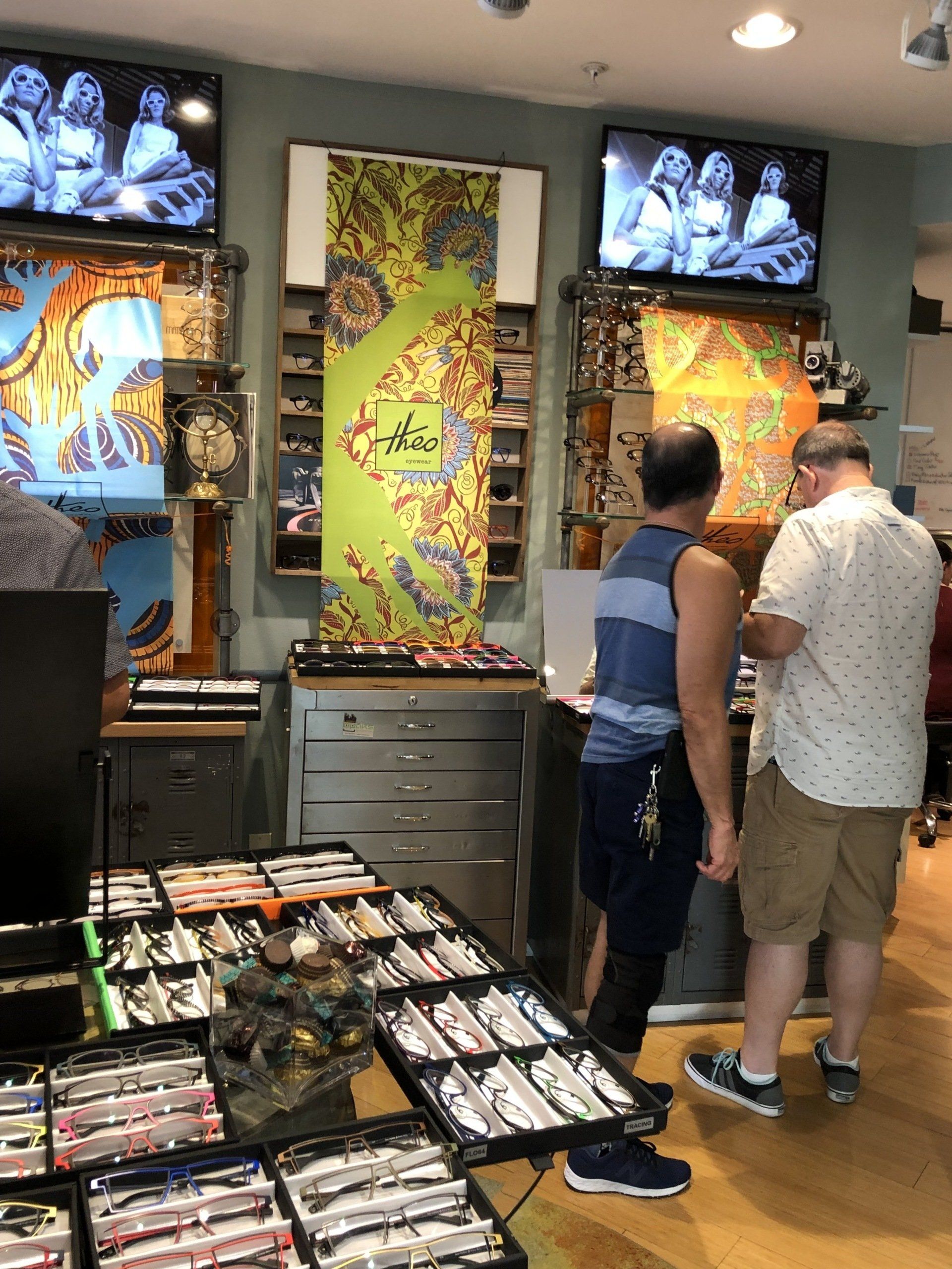 Two people looking at eyeglass frames at Theo Trunk Show Event