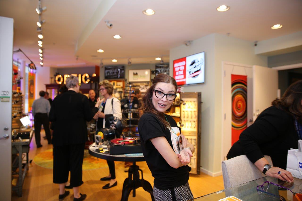 Staff member posing inside at Raise Your Glasses 2017 Event
