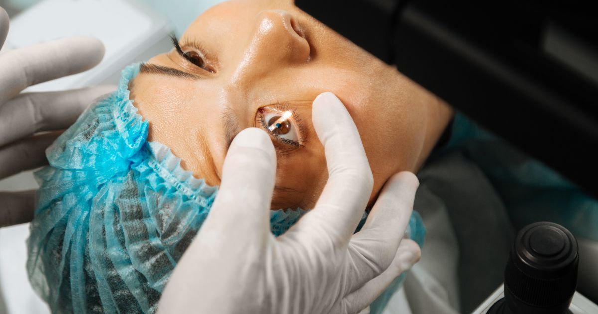 A woman is getting an eye surgery under a microscope