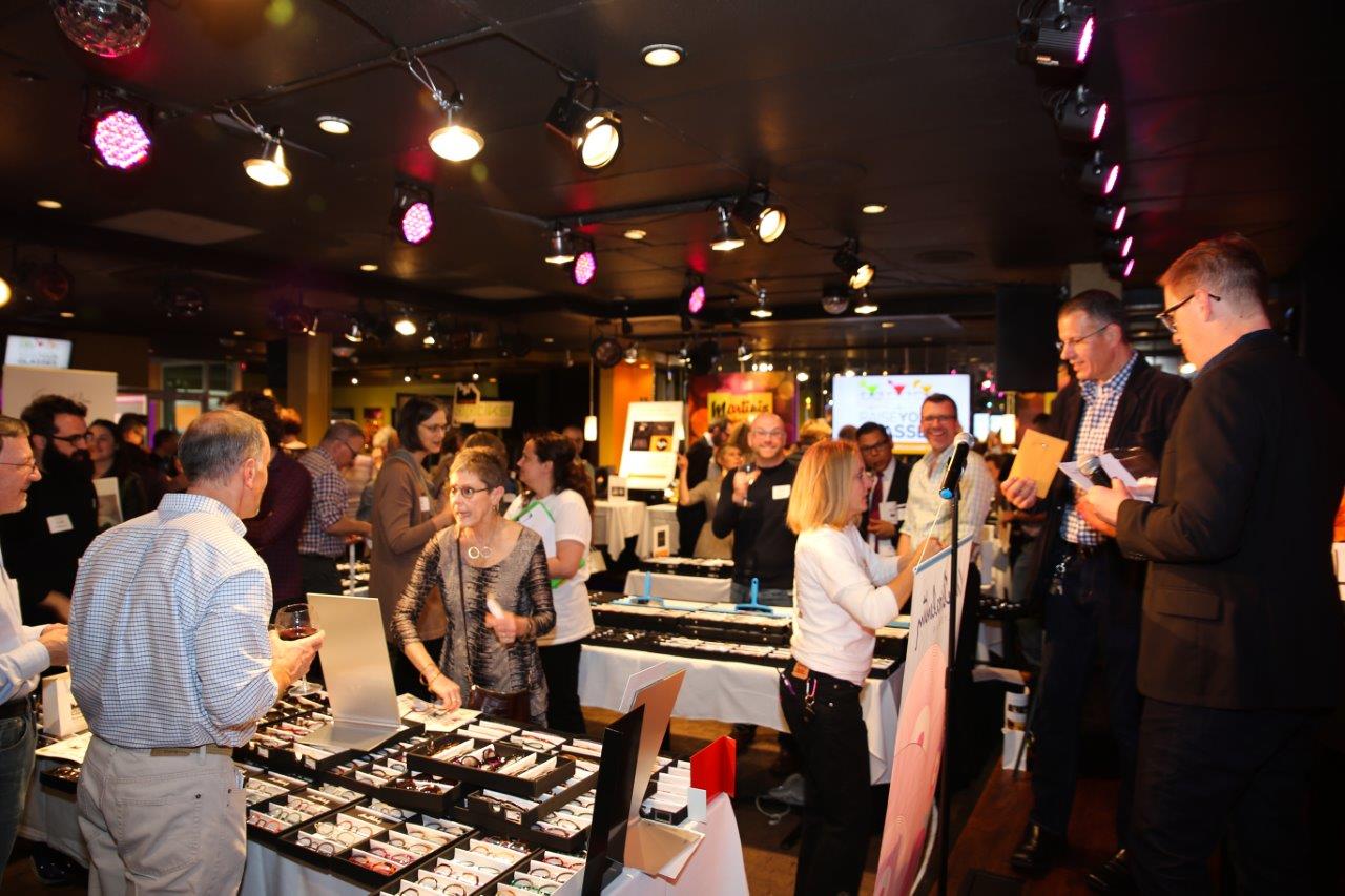 Many guests standing inside Martinis Above Fourth at Raise Your Glasses event