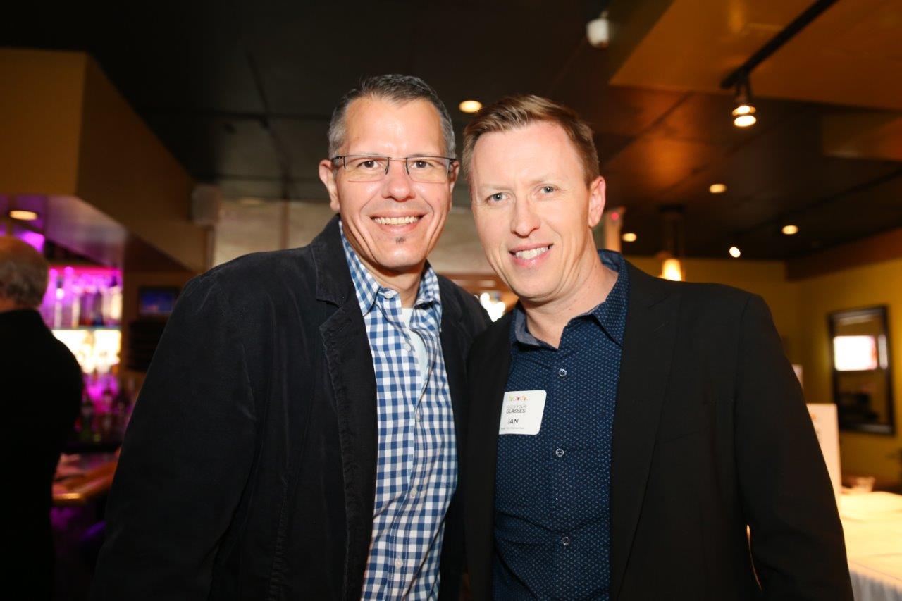 2 guests smiling inside Martinis Above Fourth at Raise Your Glasses event
