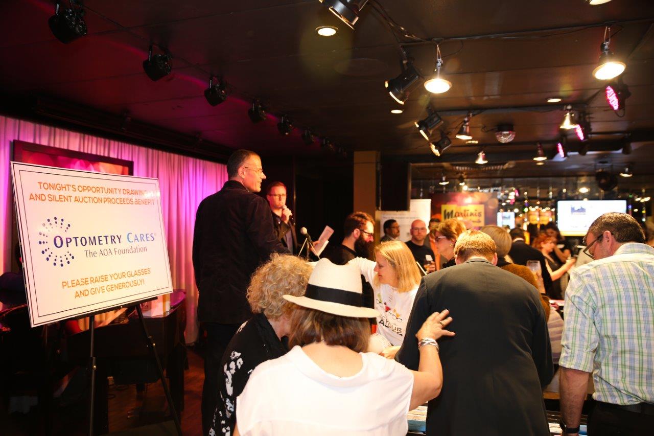 Many people enjoying Raise Your Glasses event