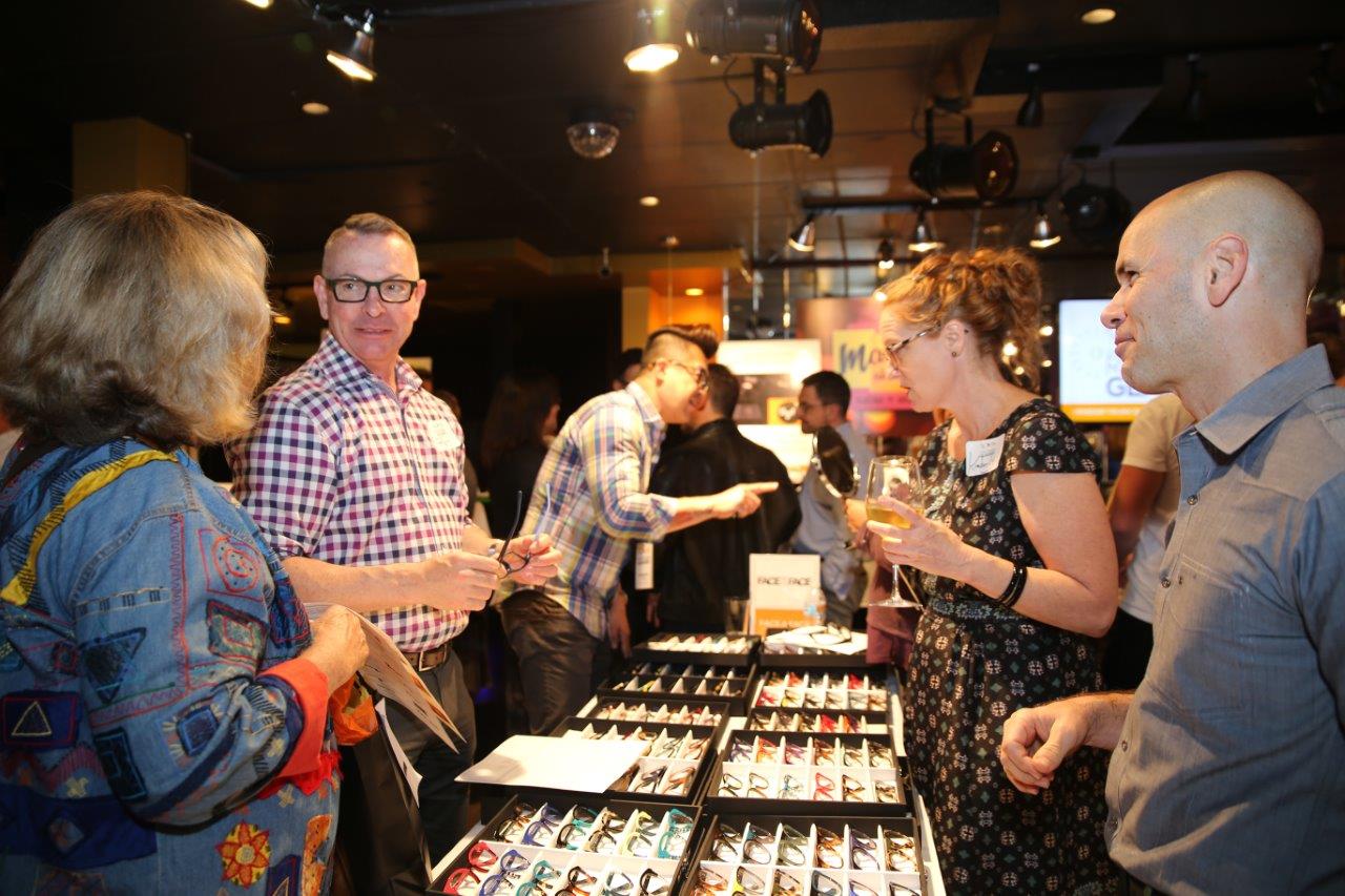 People looking at frames at Raise Your Glasses event