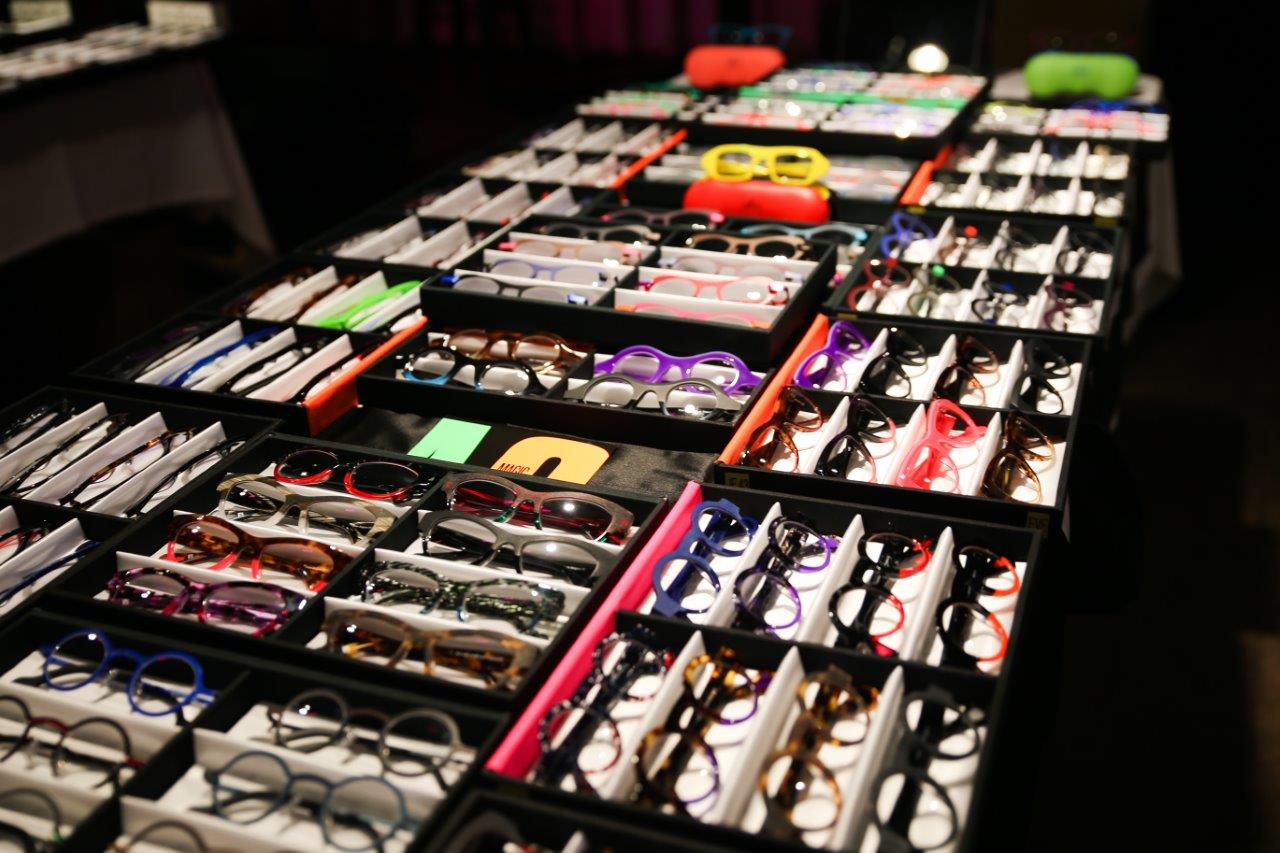 Many display boxes with various eyeglass frames at Raise Your Glasses event